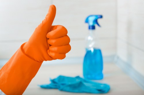 Technician carrying out deep upholstery cleaning on a lounge sofa